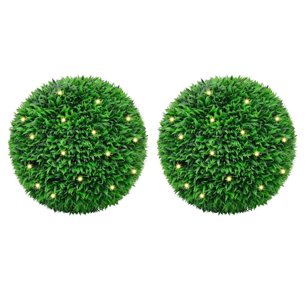 Artificial Boxwood Balls with LED Lights 2 pcs Green 55 cm displayed in a vibrant garden setting, showcasing their lush green texture and solar-powered illumination.